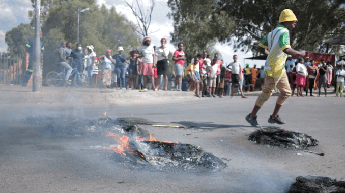 Residents block a road during a service delivery protest